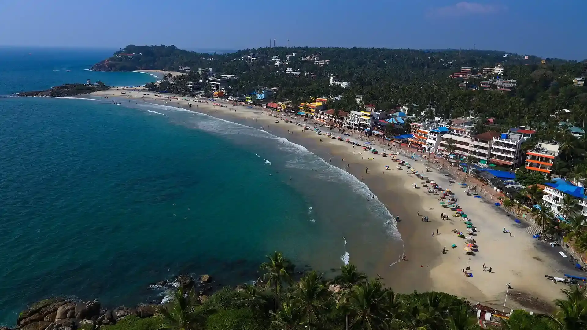Aerial view of the unique crescent shaped coastline and rocky promontories in Kovalam Kerala
