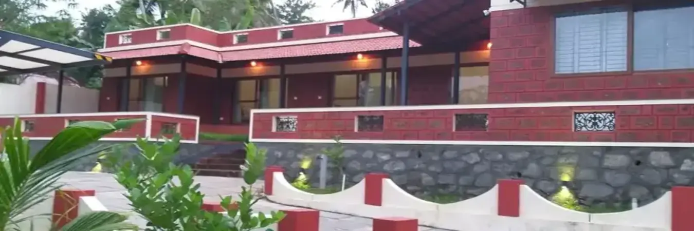 Charming red brick exterior of The Ixora Boutique Homestay in Kovalam Kerala