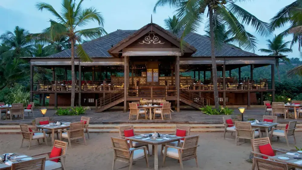 Balinese style luxury resort building and outdoor dining area at Taj Green Cove Resort Kovalam