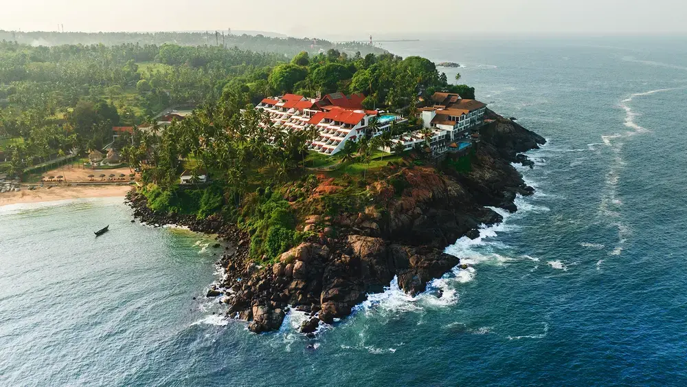 Aerial view of The Leela Kovalam Beach resort perched on a cliff above the Arabian Sea