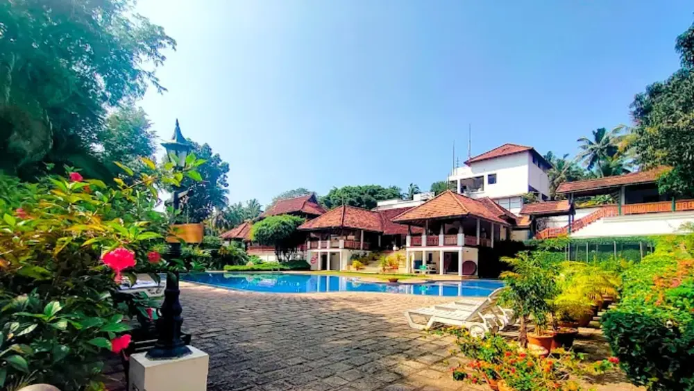 The Travancore Heritage Beach Resort traditional building exterior and swimming pool in Kovalam Kerala