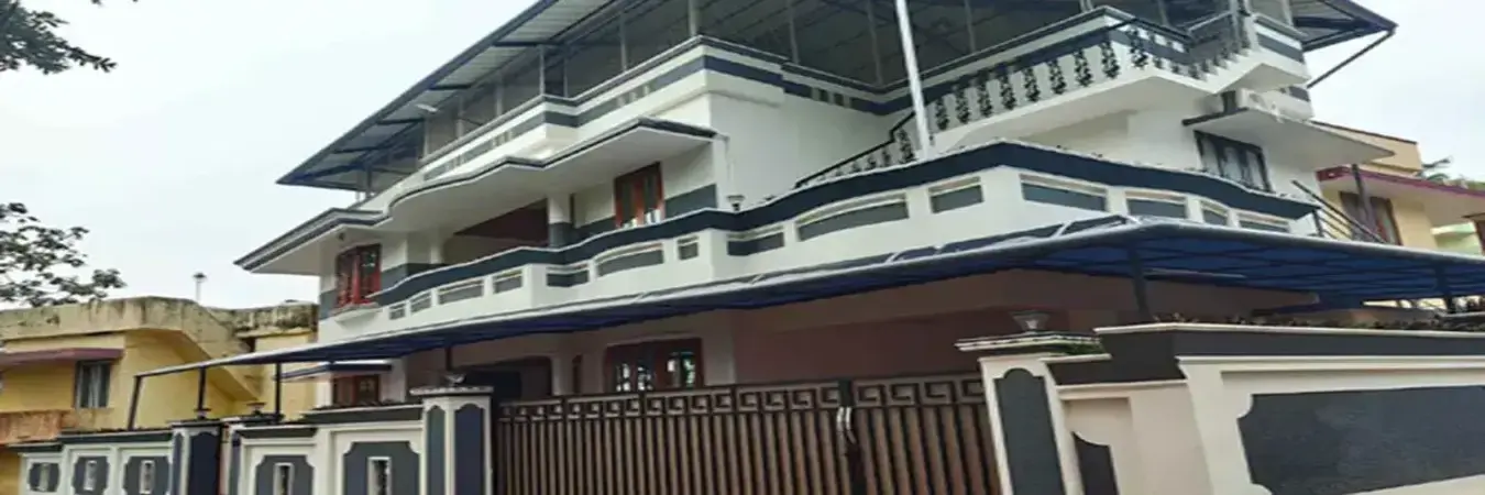 Modern multi-story building exterior and architecture of Therickal Homes Homestay Kovalam.