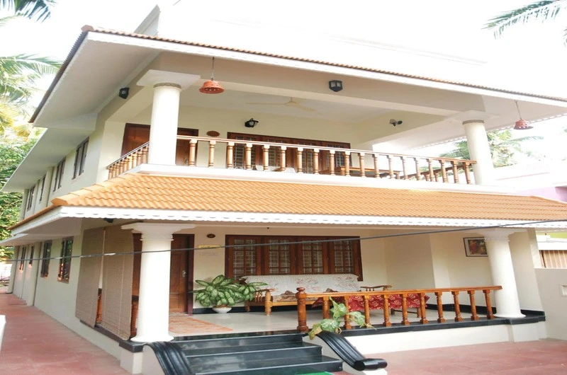 Two-story traditional Kerala-style building architecture of Devikripa Homestay in Pachalloor Kovalam