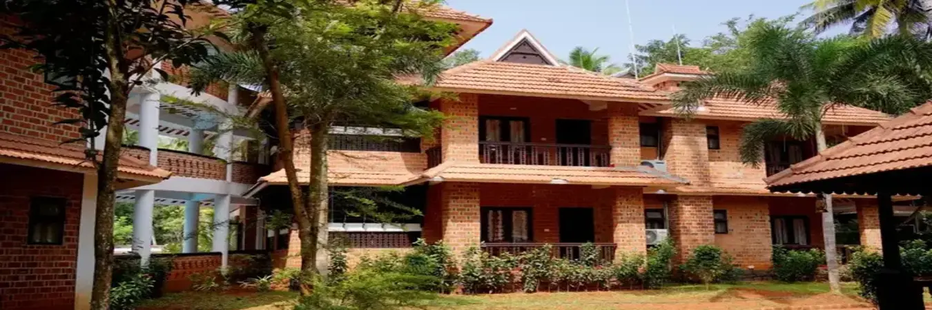 Traditional Kerala heritage architecture with terracotta tiled roofs at Gods Own Country Ayurveda Resort Chowara
