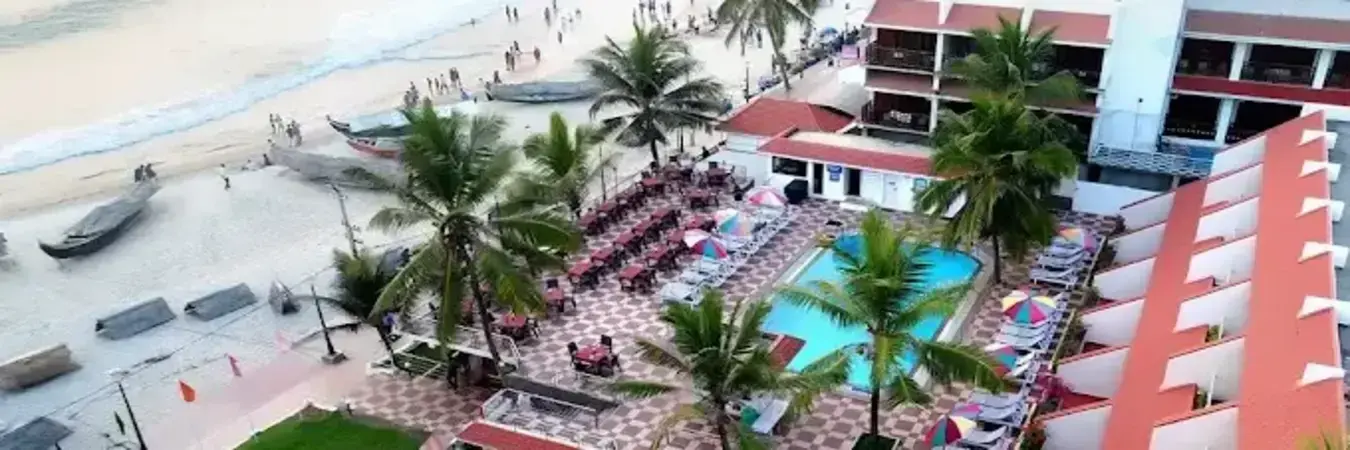 Beachfront relaxation deck and swimming pool at Hotel Sea Face Kovalam near Lighthouse Beach