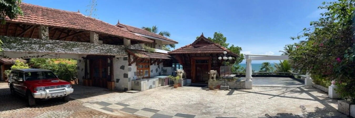 Wide angle panorama of the traditional Kerala heritage building facade at Thayil Kadaloram Homestay Kovalam