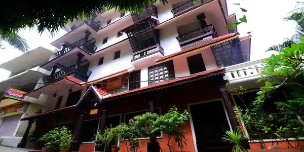 Guest room balconies and exterior facade of Kovalam Beach Hotel.