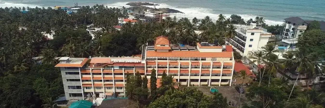 Elevated view of Swagath Holiday Resort surrounded by lush coastal greenery near Lighthouse Beach Kovalam