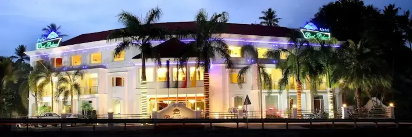 Illuminated modern building facade of Hotel Port Palace Kovalam near Vizhinjam harbor at night