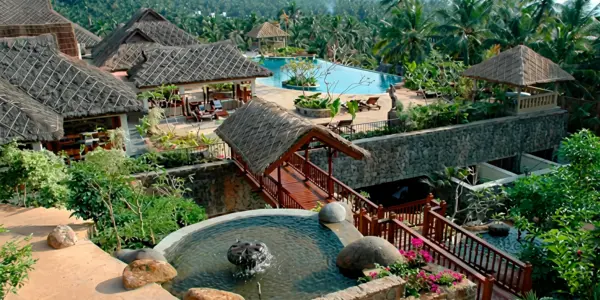 Luxury hillside resort cottages nestled in tropical greenery at Taj Green Cove Resort and Spa Kovalam Kerala.