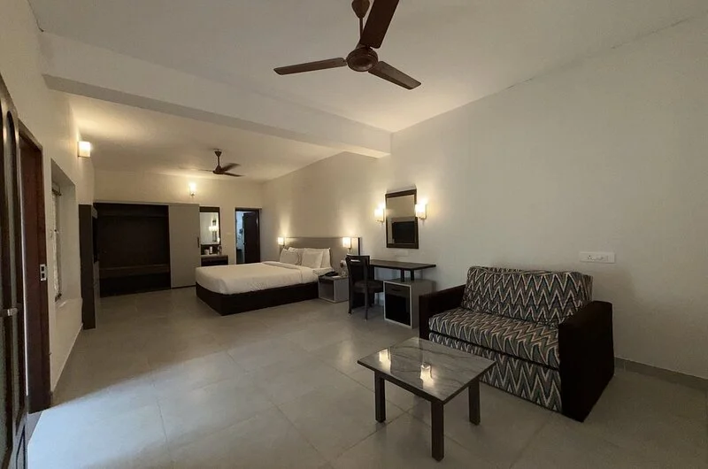 Deluxe family suite room interior and guest seating lounge inside Abad Harmonia Kovalam.