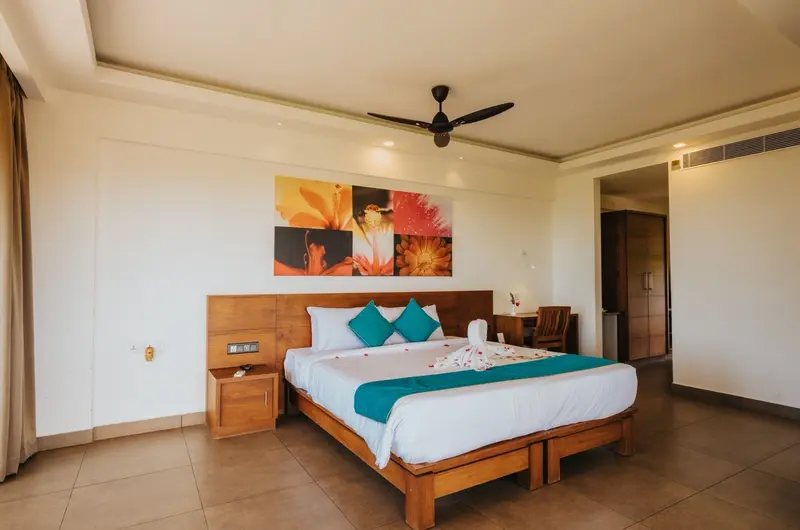 Premium deluxe room accommodation with modern furnishings at Aadisaktthi Leisure Resort Kovalam.
