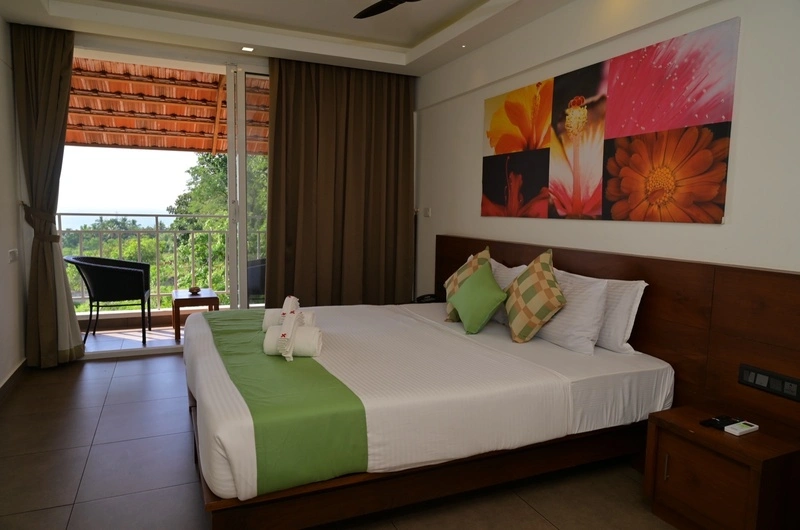 Premium air conditioned guest room at Aadisaktthi Leisure Resort featuring scenic window views.