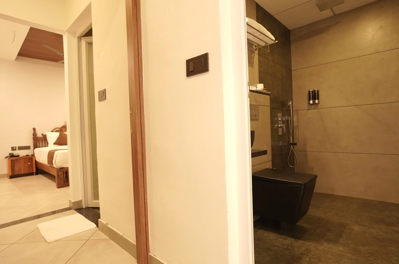 Clean modern attached bathroom interior featuring contemporary fittings at Aadisaktthi Leisure Resort.