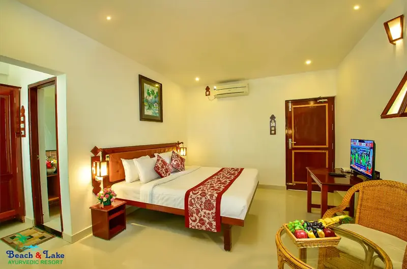 Clean and comfortable air-conditioned guest room layout at Beach and Lake Ayurvedic Resort.