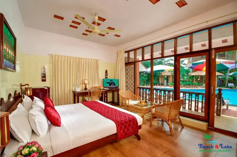 Premium twin bedroom accommodation with wide glass windows at Beach and Lake Ayurvedic Resort.