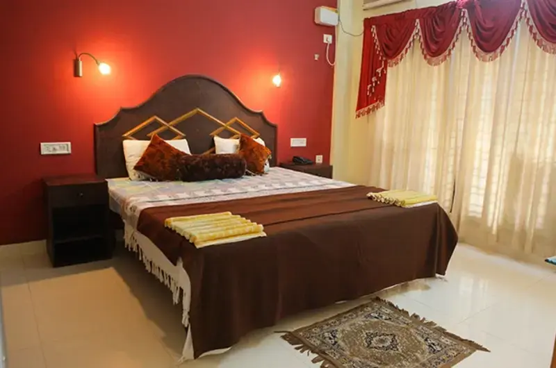 Premium double bedroom accommodation featuring warm wooden furnishings at Golden Sands Beach Resort Kovalam.