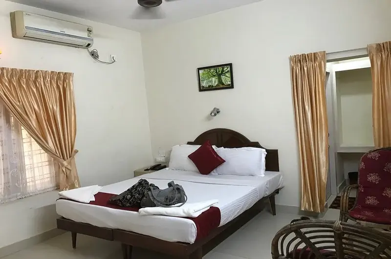 Cozy deluxe bedroom setup with modern amenities at Hawah Beach Resort Kovalam