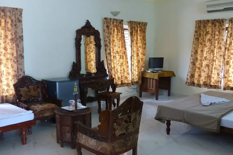 Large resort guest room with classic wooden furniture at Hawah Beach Resort