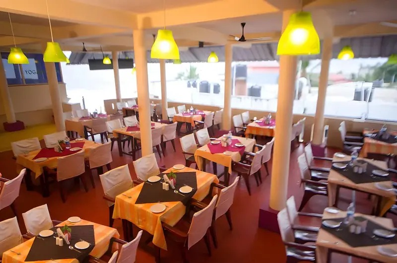 In house multi cuisine restaurant with vibrant lighting at Hawah Beach Resort