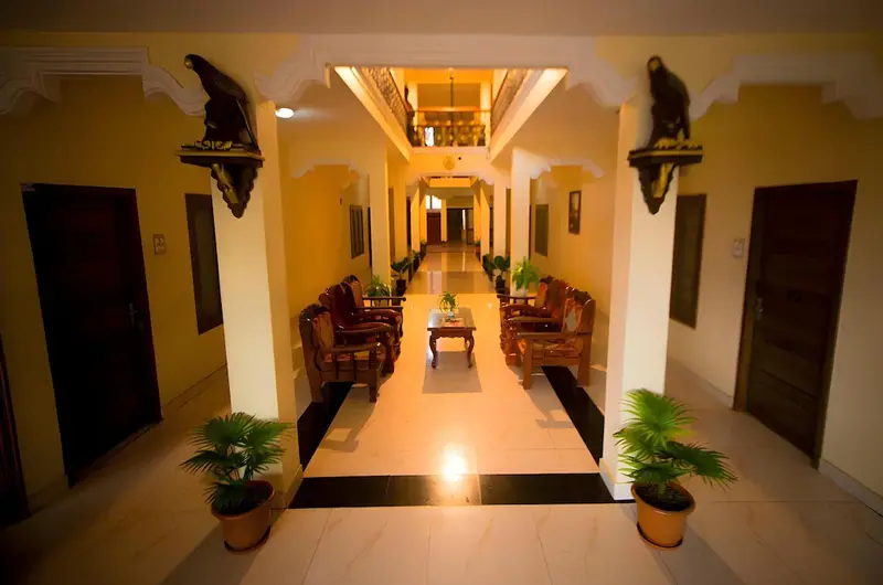 Well lit indoor hallway and room entrances at Hawah Beach Resort Kovalam