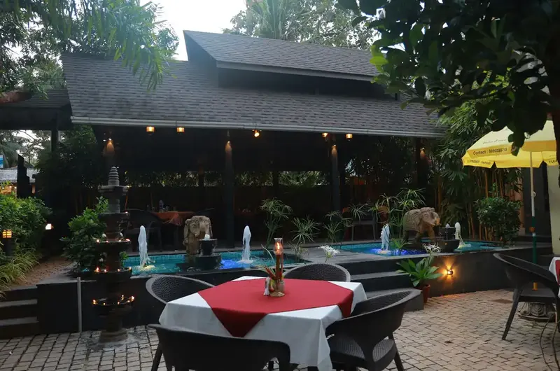 Relaxing evening outdoor seating area with traditional architecture at Ideal Ayurvedic Resort Kovalam.