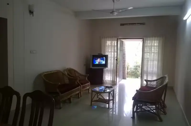 Spacious apartment living room interior leading out to a private balcony at Indeevaram Apartments Kovalam.