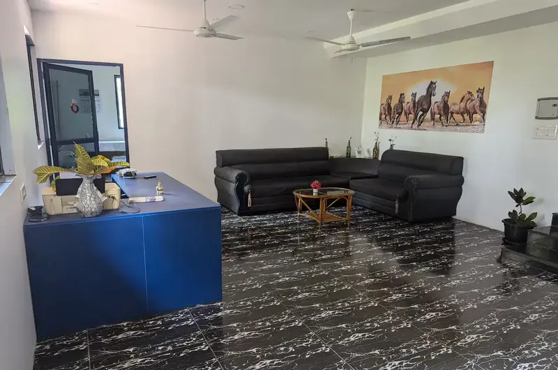 Modern guest living room lounge area with sofa seating inside Indeevaram Apartments Kovalam.