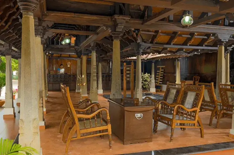 Open air multi cuisine restaurant with traditional wooden pillars at Isola Di Cocco Kovalam