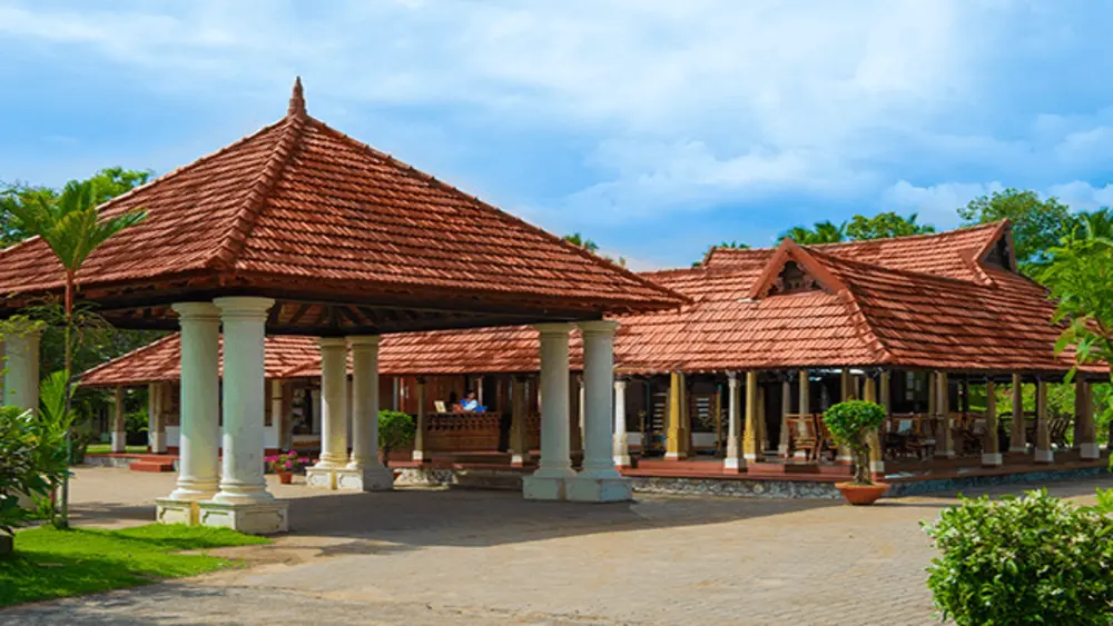 Traditional Kerala architecture and heritage villa exterior at Isola Di Cocco Beach Resort Poovar