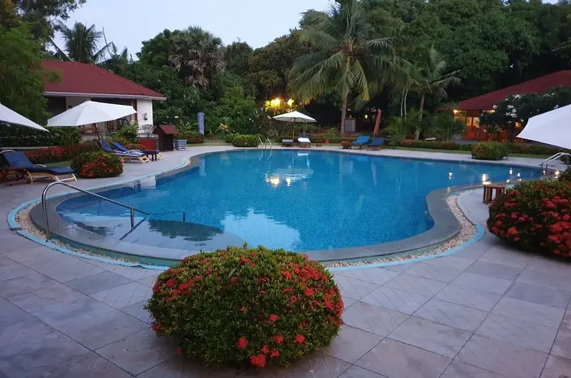 Large outdoor swimming pool and relaxation area at Poovar Island Resort