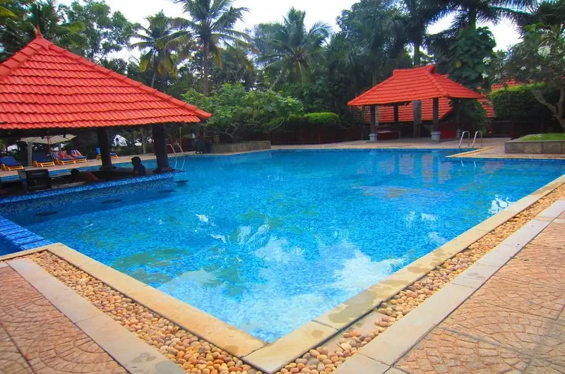 Beautiful swimming pool overlooking the tropical landscape at Poovar Island Resort Kerala