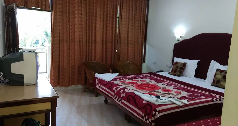 Luxury guest bedroom with private balcony entry at Sagara Beach Resort Kovalam