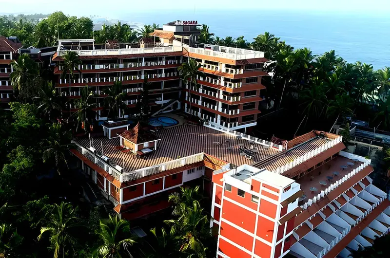 Sagara Beach Resort Kovalam multi story hotel building surrounded by coconut trees