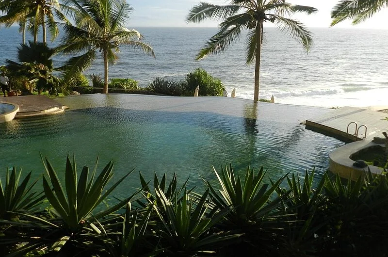 Luxury infinity swimming pool overlooking the Arabian Sea at Niraamaya Retreats Surya Samudra Kovalam