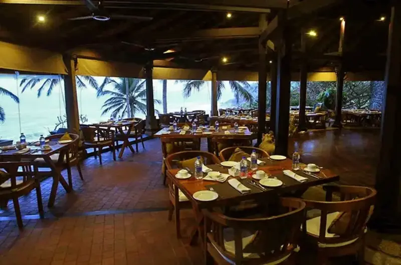 Fine dining open air restaurant with ocean views at Niraamaya Retreats Surya Samudra Kovalam
