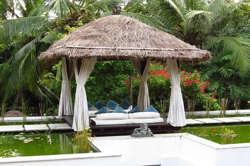 Oceanfront relaxation gazebo with thatched roof at Niraamaya Retreats Surya Samudra