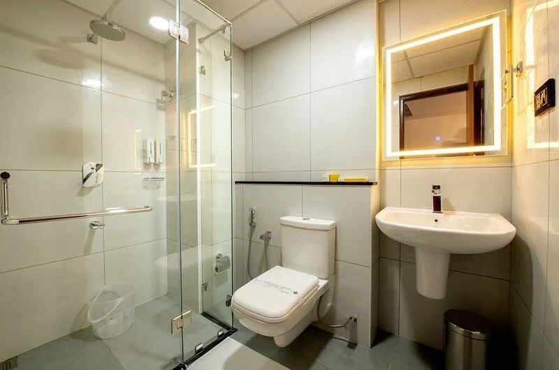 Clean ensuite bathroom layout featuring a contemporary vanity wash basin at Swagath Holiday Resort