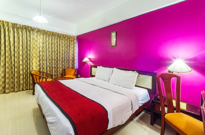 Premium AC guest room featuring contemporary interiors and vibrant decor at Swagath Holiday Resort