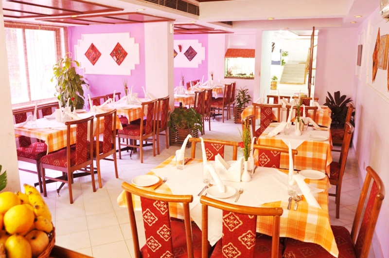 In house multi cuisine restaurant dining hall setup at Swagath Holiday Resort Kovalam