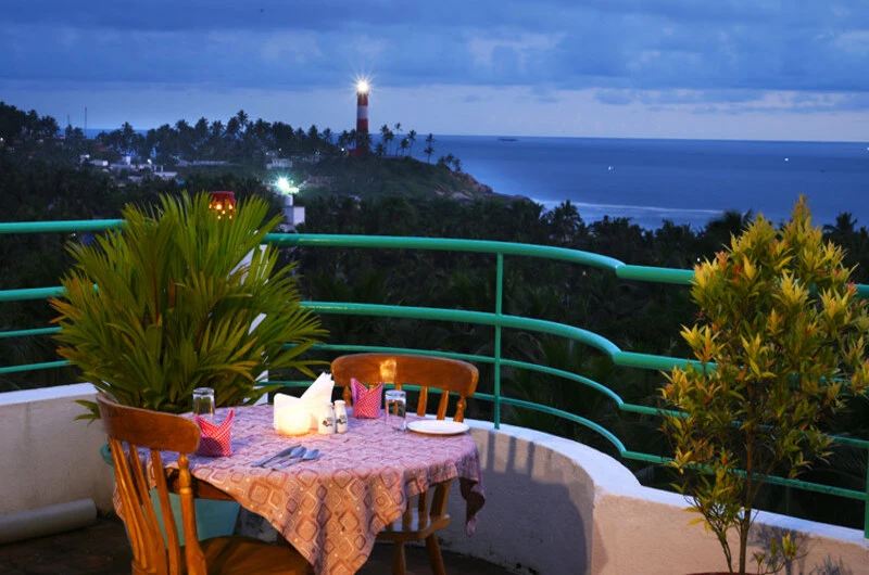 Open air terrace dining setup with panoramic ocean views at Swagath Holiday Resort Kovalam