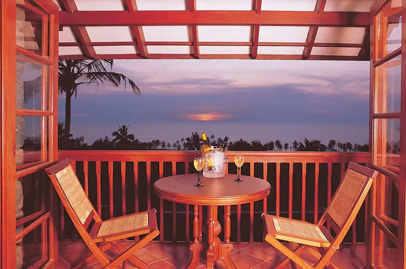 Private balcony dining area with scenic ocean views at Taj Green Cove Resort Kovalam