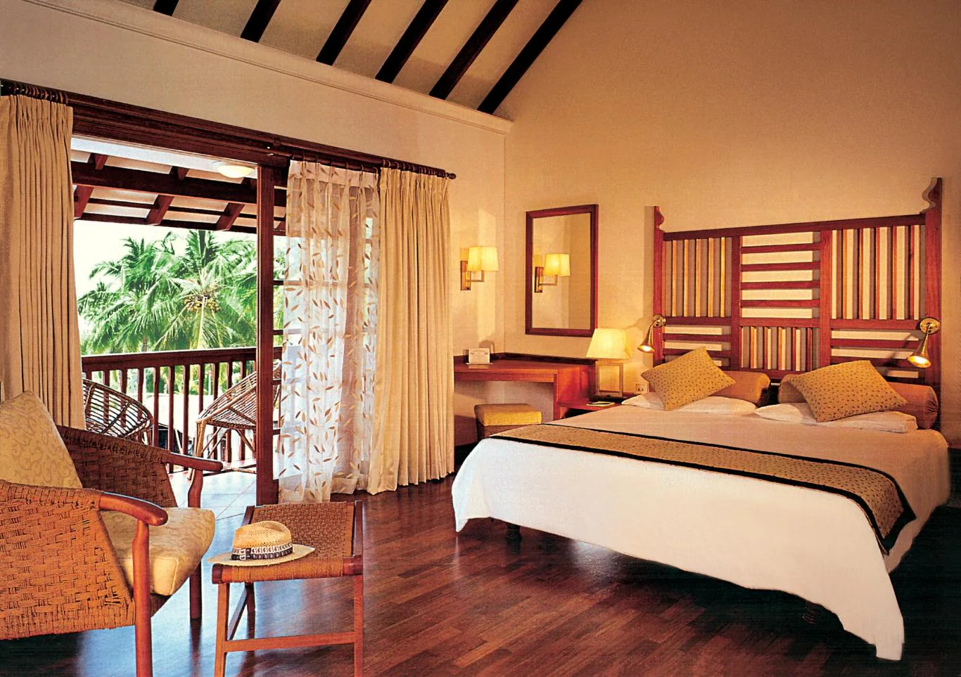 Premium cottage bedroom accommodation with heritage wooden ceiling at Taj Green Cove Resort Kovalam