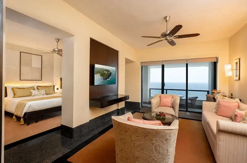 Premium suite room living area with panoramic beach views at The Leela Kovalam hotel