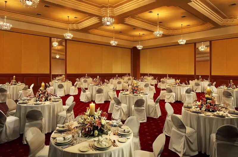 Elegant fine dining restaurant interior with traditional seating at The Leela Kovalam
