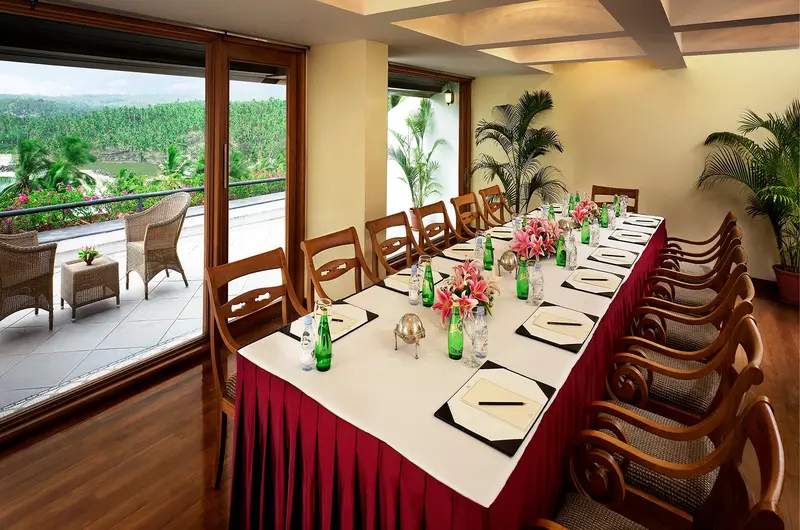 Luxury indoor banquet dining table arrangement for corporate events at The Leela Kovalam
