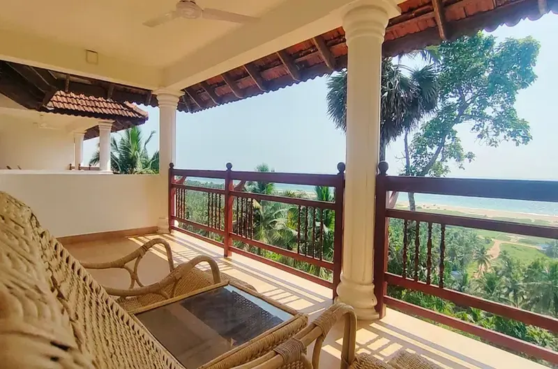 Traditional wooden balcony with sea views at The Travancore Heritage Beach Resort Kovalam
