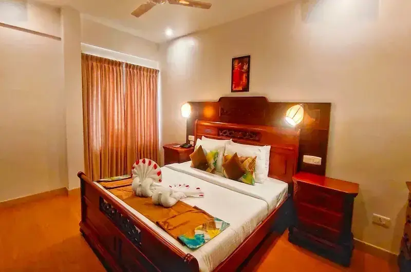 Luxury heritage room interior with warm ambient lighting at The Travancore Heritage Beach Resort Kovalam