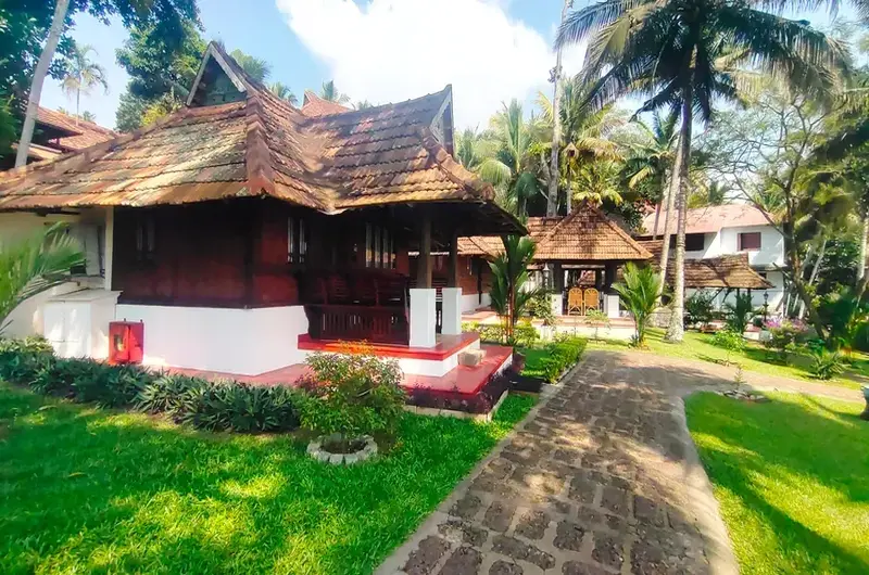 Traditional Kerala heritage cottage exterior with tiled roof at The Travancore Heritage Beach Resort Kovalam