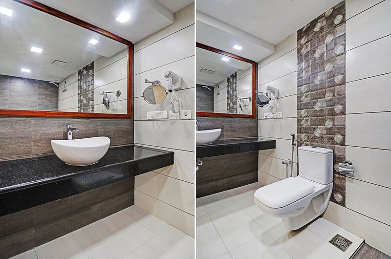 Clean ensuite bathroom layout with western toilet facilities at Treebo Trend Linchu Ayur Resort Kovalam